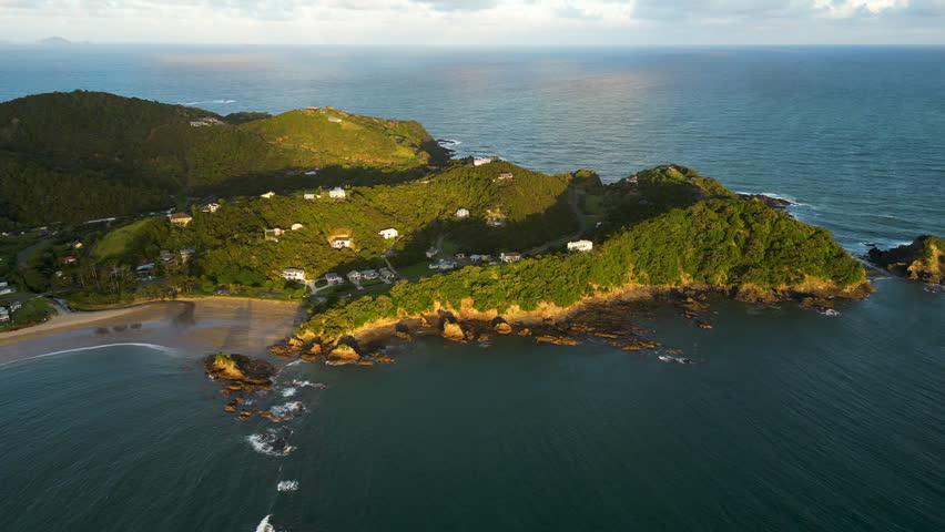 Scenic aerial view of Wellingtons bay new Zealand drone fly above stunning seascape during warm golden hous