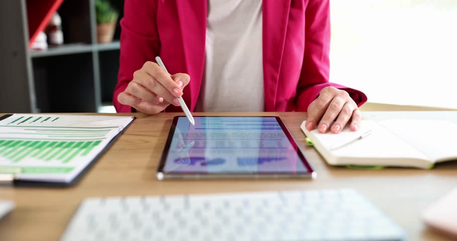 Woman examines statistics and audits swiping pages on tablet Royalty-Free Stock Footage #1101909061
