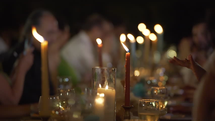 Closeup candles burning on table. Dinner party friends. Acoholic drinks holidays, festivals, and events. copy space 