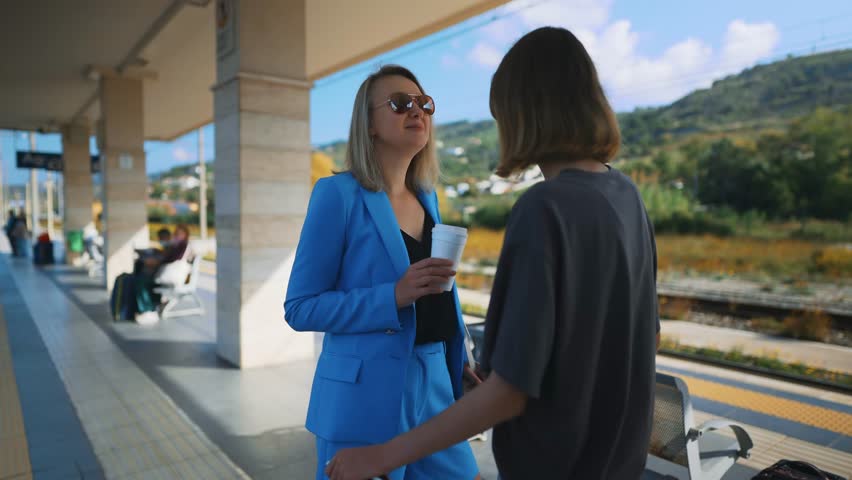 Daughter see off her mother on a journey at the station.