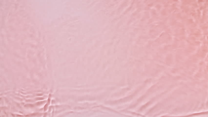 Water with reflections sunlight and shadows. Slow motion of waves water on pink background. Sun and shadows. Video for design, advertising, products.