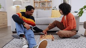 Chess, games and couple on floor in home playing board games for bonding, relax and quality time. Love, dating and happy black man and woman in living room having fun, problem solving and strategy - Powered by Shutterstock - Get 15% off with code: PIKWIZARD15