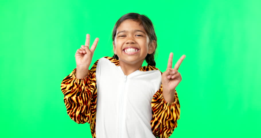 Happy, dance and peace sign with girl in green screen studio for kindness, positive and pride. Happiness, support and gesture with young child on background for cheerful, carefree and confidence