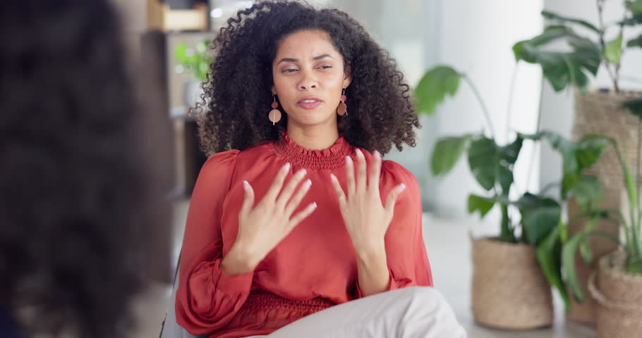 Woman patient talking in counseling session, therapy or psychology for stress, anxiety or mental health advice. Client or person speaking to psychologist, therapist or professional meeting for help | Shutterstock HD Video #1101918127