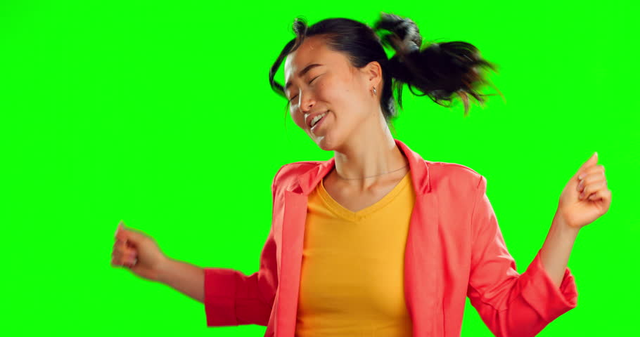 Woman, happy dance and freedom on green screen, background and studio for fun party celebration. Dancing, smile and asian model with excited energy to celebrate happiness, groovy music and winning Royalty-Free Stock Footage #1101918161