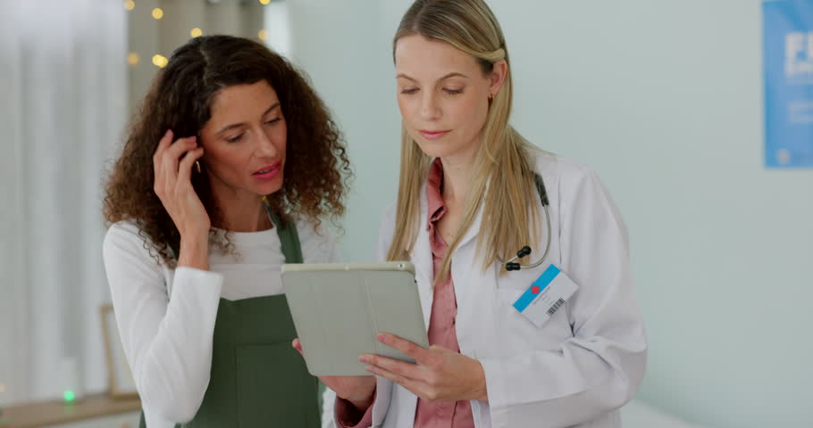 Doctor consulting patient with tablet in office for online results, insurance advice and report in healthcare communication. Medical expert, women or people on digital technology in consultation talk | Shutterstock HD Video #1101919873