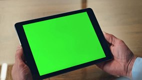 Closeup chromakey tablet man hands hold in office. Unrecognizable businessman checking messages trading news on green screen device. Unknown ceo using smart control app. Worker talking virtual call  - Powered by Shutterstock - Get 15% off with code: PIKWIZARD15