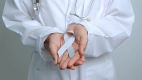 Brain Cancer Awareness May month, Doctor with grey color Ribbon for supporting life people. Healthcare and World cancer day concept - Powered by Shutterstock - Get 15% off with code: PIKWIZARD15