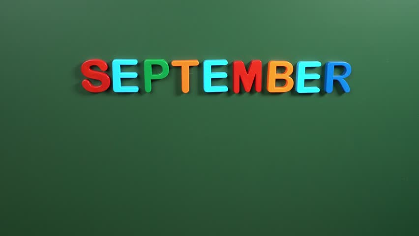 Hand sticking a sticker 28 September calendar day on school board. 28 date of September. Twenty eighth day of September. 28th date number. 28 day calendar. Twenty eight date. World Rabies Day