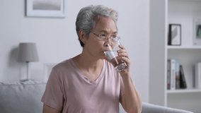 Mature Asian woman taking pill and vitamin. - Powered by Shutterstock - Get 15% off with code: PIKWIZARD15