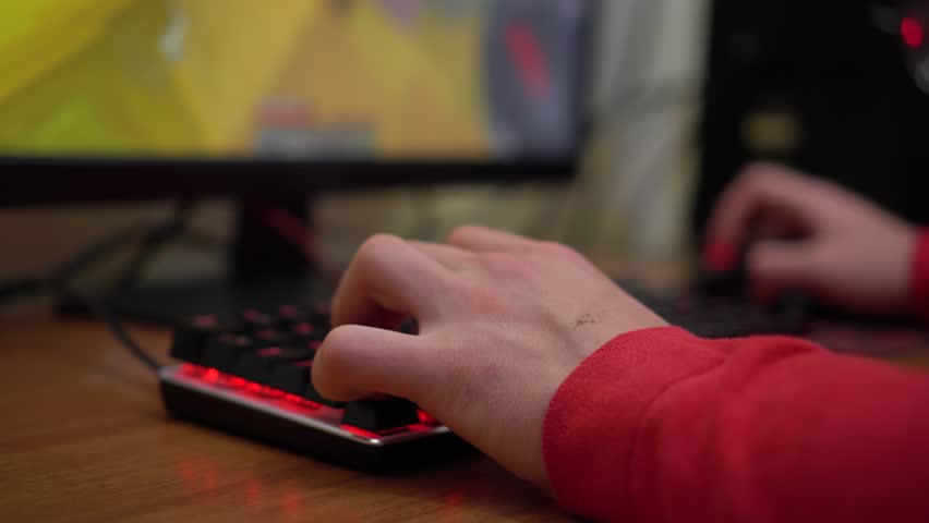 E-game. Hands on the keyboard close-up. A Boy Playing A Video Game. Multiplayer online battle arena Royalty-Free Stock Footage #1101924681