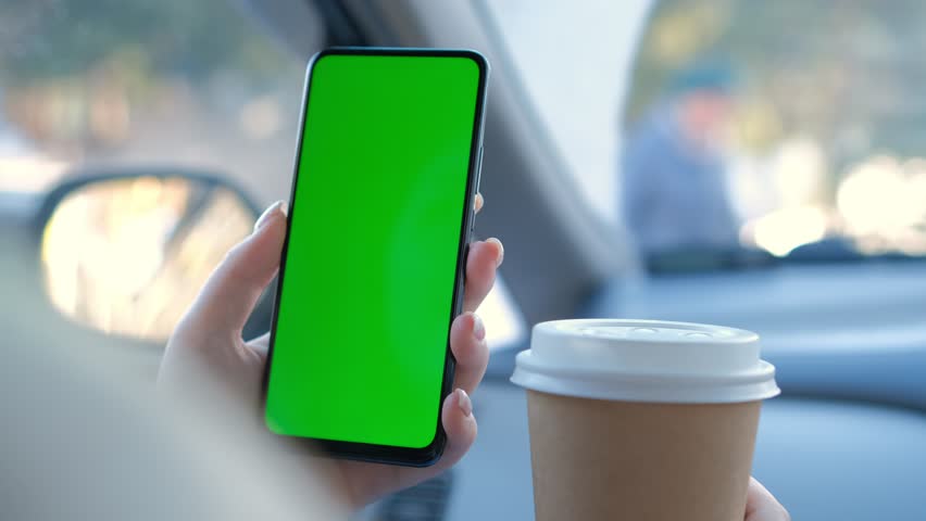 The green screen of the phone is chroma key in the car 4K Royalty-Free Stock Footage #1101926347
