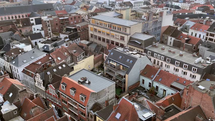 Panoramic aerial view of the city of Ghent, Belgium. Cloudy sky with sunbeams through the clouds at sunset. High quality 4k footage