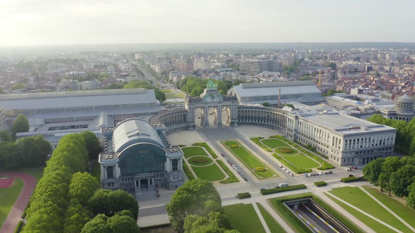 Inscription on video. Brussels, Belgium. Park of the Fiftieth Anniversary. Park Senkantoner. The Arc de Triomphe of Brussels (Brussels Gate). Neon white effect text, Aerial View
