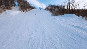 Fpv aerial photography of a snowboarder at a ski resort, fpv shooting of a riding snowboarder