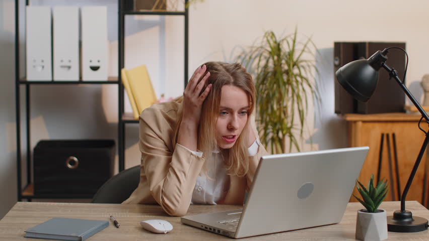 Irritated shocked young business woman while working on laptop, unexpected online website problem, computer virus data loss by hacking. Freelancer feeling mad about broken notebook at office workplace Royalty-Free Stock Footage #1101935507