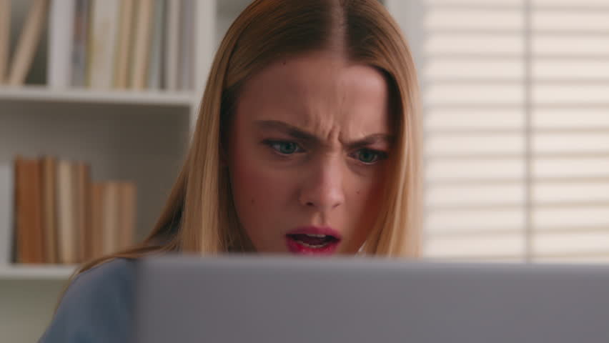 Close up angry upset Caucasian woman user using laptop in home office frustrated mad confused shocked computer problem say what shock failure online stressed girl businesswoman mistake software error | Shutterstock HD Video #1101936731