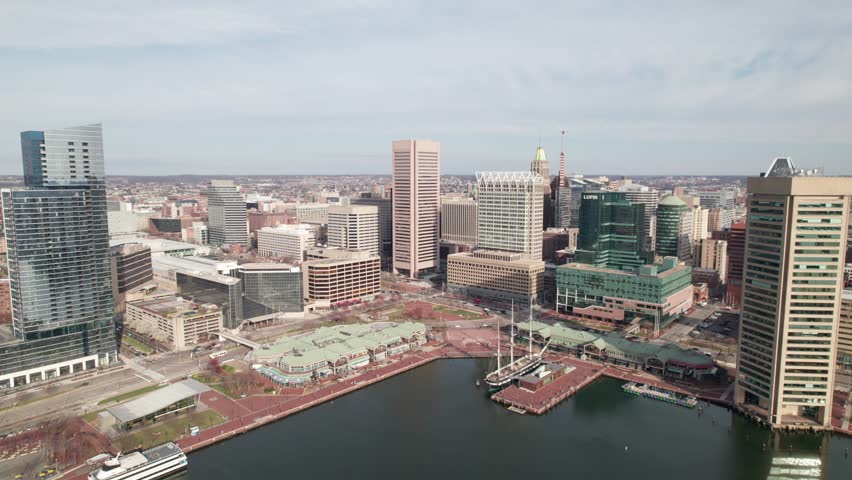 Very long drone pull-out shot of downtown Baltimore, inner harbor. 4K