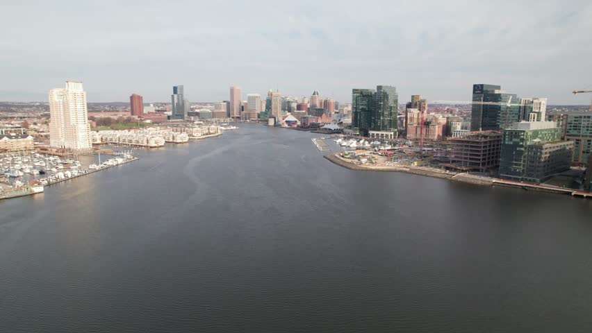 High aerial of Baltimore, MD. Harbor and waterfront areas with city skyline, 4K