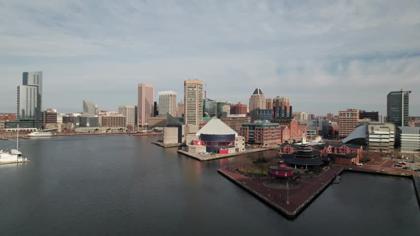 Low rising aerial of National Aquarium in Baltimore, MD, downtown skyline