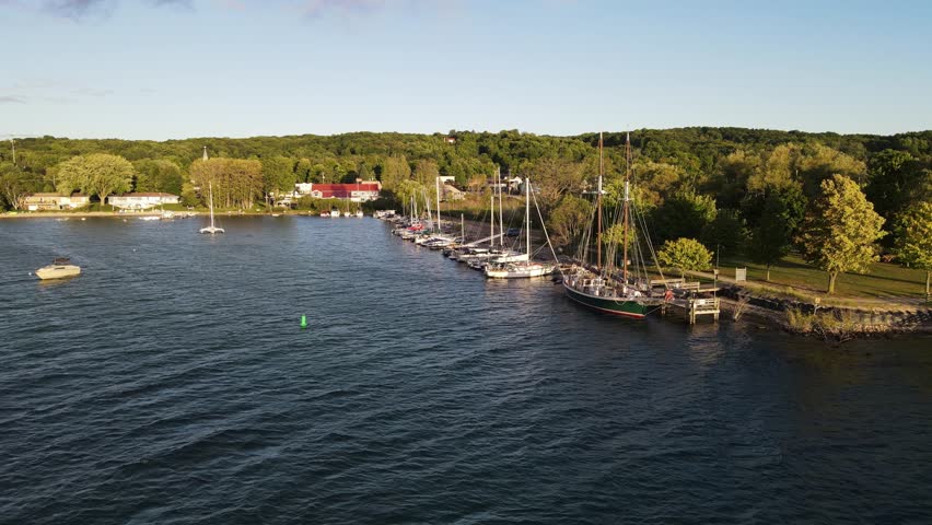 Ship And Sailboats Docked At Suttons Bay In Michigan On A Sunny Day In USA. - aerial