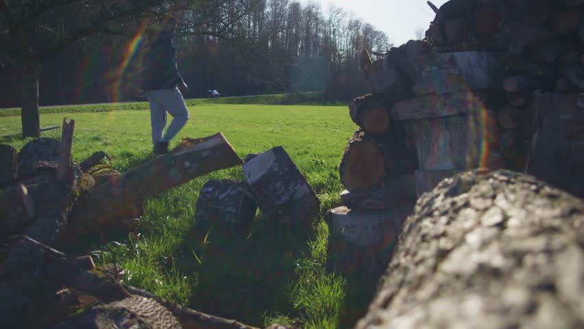 Cars Passing As Black Farmer Surveys the Landscape - Close Up of Lumber In Field in 4K | Red Komodo Cooke Mini S4i Lens High Quality (30 Fps)