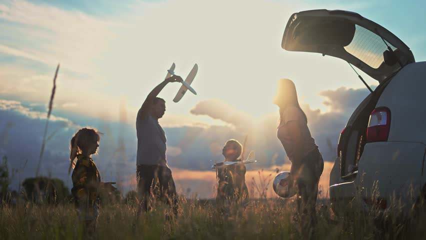 happy family children stand together next to the car watching the sunset silhouette in the park. family travel concept. happy sunlight family standing dream, back watching journey in the park Royalty-Free Stock Footage #1101944739