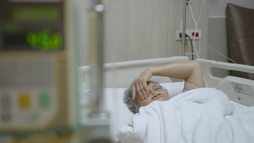 Elderly woman admitted to the hospital receiving treatment for sickness, the doctor gives saline with an automatic saline dispenser. | Shutterstock HD Video #1101945477