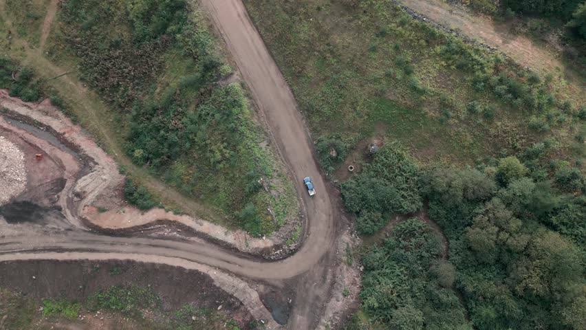 Aerial view of a quarrying vehicle on a dusty road