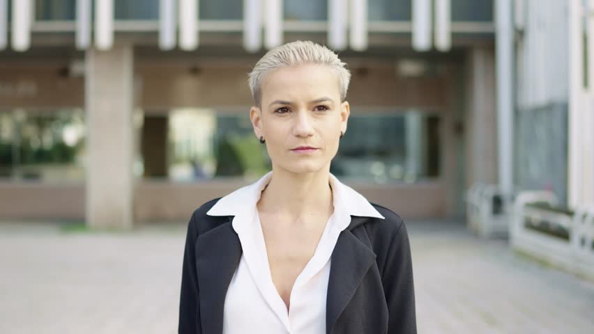 Businesswoman with short hair smiling at camera | Shutterstock HD Video #1101955067