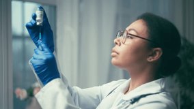 Female lab scientist preparing syringe with covid medicine for testing, research - Powered by Shutterstock - Get 15% off with code: PIKWIZARD15