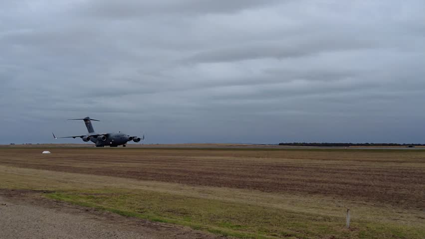 Boeing C-17A Globemaster III Cargo Plane Running In Low Speed On Airfield Tarmac. close-up, tracking shot
