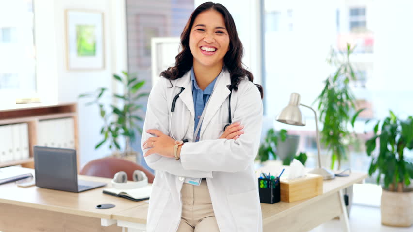 Happy asian woman, doctor and confidence with arms crossed for healthcare on office desk at hospital. Portrait of confident female medical professional standing and smiling in health advice at clinic | Shutterstock HD Video #1101962755