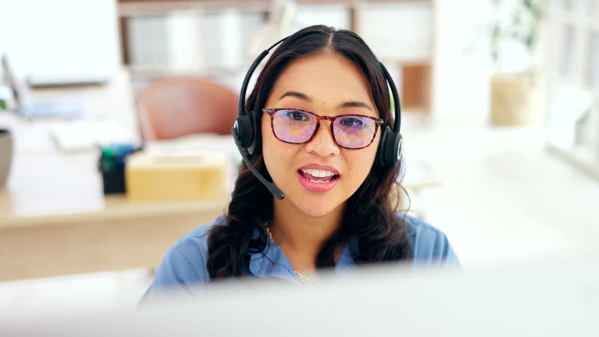 Call center, computer and happy woman, agent or consultant technical support, online solution or help desk. International virtual assistant or friendly asian person consulting and talking on desktop | Shutterstock HD Video #1101962765