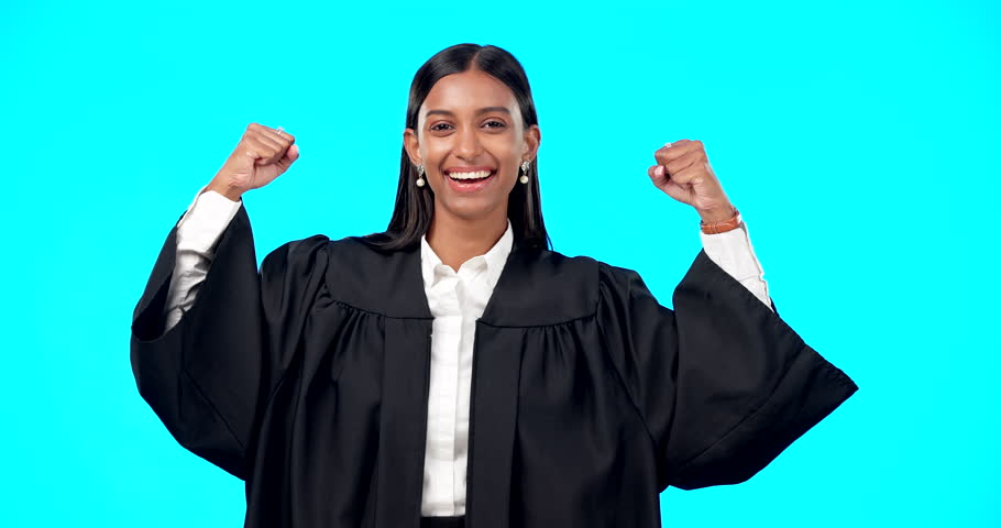 Strong woman lawyer, face and studio with bicep muscle celebration, smile or legal victory by blue background. Judge, happy and indian law expert in portrait to celebrate empowerment by backdrop | Shutterstock HD Video #1101962835