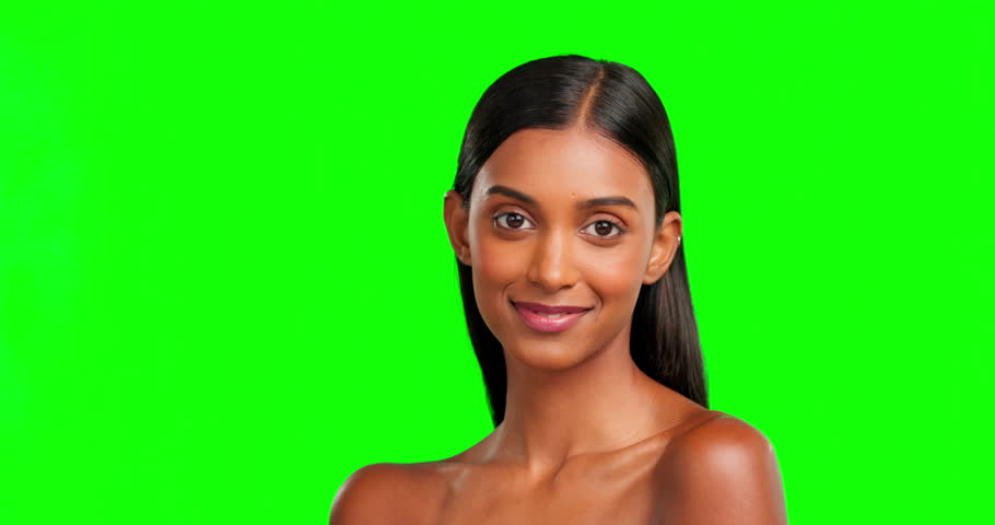 Face, wink and beauty of woman on green screen in studio isolated on background. Natural skincare, makeup cosmetics and portrait of Indian model or happy person with facial treatment for healthy skin | Shutterstock HD Video #1101963065