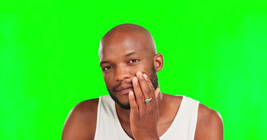 Grooming, beard and face of a black man on a green screen isolated on a studio background. Feeling, looking and portrait of an African guy touching his facial hair for maintenance on a backdrop | Shutterstock HD Video #1101963149