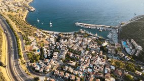 Drone footage capturing the breathtaking coastal scenery of Kalkan, a charming holiday town near Kaş, with its marina, turquoise waters, and picturesque Mediterranean setting in Antalya, Turkey.