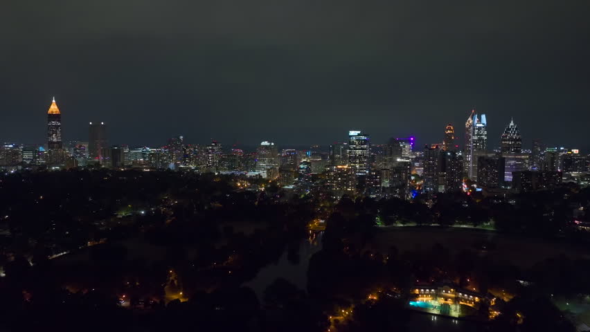 View from above of brightly illuminated high skyscraper buildings in downtown district of Atlanta city in Georgia, USA. American megapolis with business financial district at night