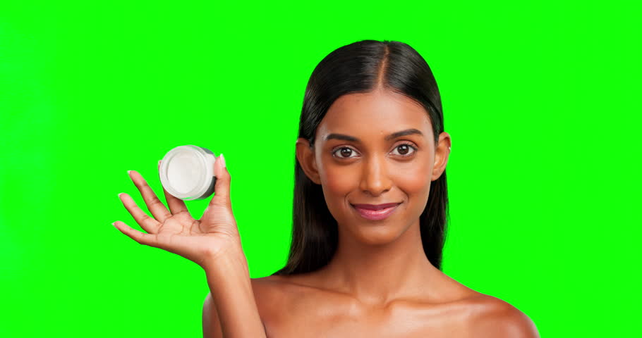 Woman, face and cream jar on green screen, smile and color background in studio for cosmetics. Portrait, beauty lotion and happy female model with container, glow or skincare results of facial makeup | Shutterstock HD Video #1101967217