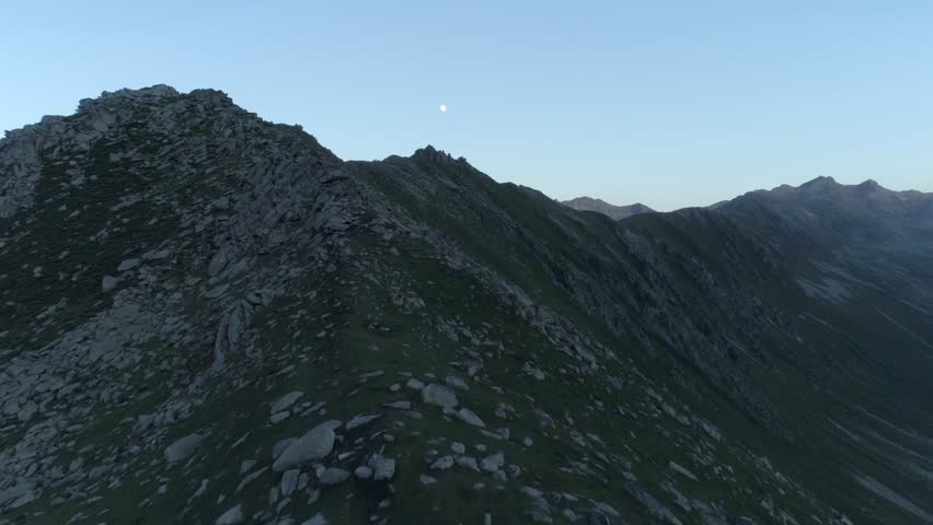Magnificent view of the moon on top of the mountains