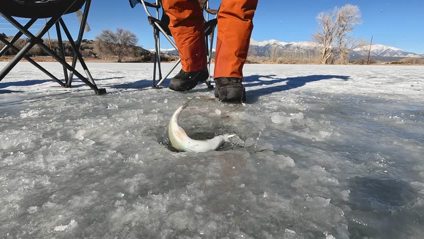 Ice fishing a mountain lake Colorado