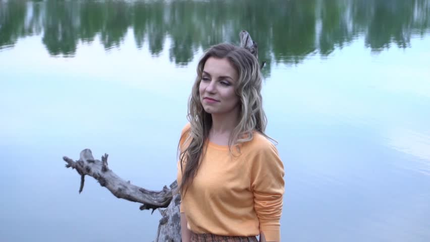 Slow Motion beautiful girl near pond in urban outdoor recreation area