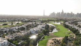 A drone shot footage in Emirates Hills captures stunning aerial views of the luxurious residential community, showcasing its beautifully landscaped gardens, winding roads, and elegant villas.