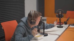 a man films himself on a smartphone as he eats instant noodles.slow motion video. High quality Full HD video recording