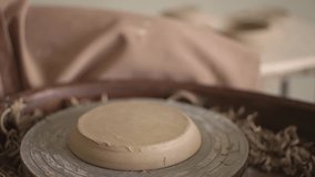 work on a potter's wheel. a woman fixes a clay product with small pieces of clay. High quality Full HD video recording