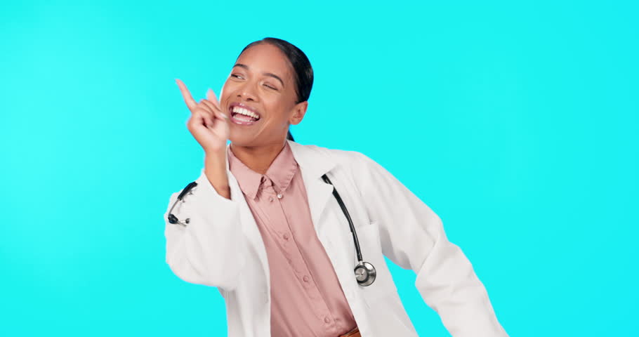 Doctor, woman and dancing celebration in studio for advice, healthcare and success in career by blue background. Young female medic, funky dance and celebrate success, freedom and funny time at job | Shutterstock HD Video #1101978315