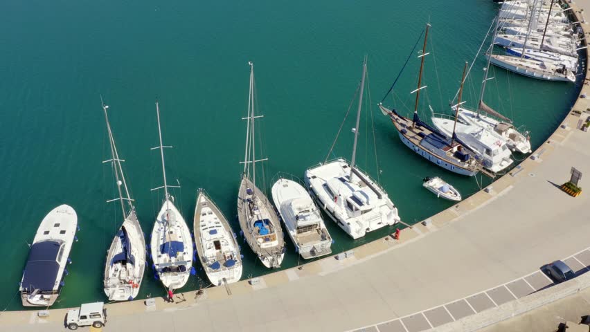 Aerial view of Tourist Port of Riva di Traiano located in Civitavecchia, near Rome, Italy. There are many boats moored at the marina.