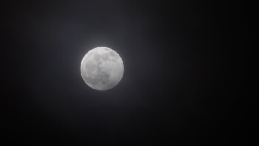 full moon moving between clouds, 4k Royalty-Free Stock Footage #1101980183