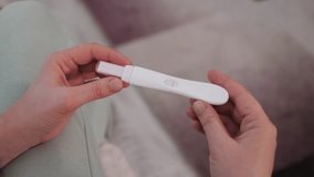 Woman with anxious feelings. Girl with a negative pregnancy test. Close-up of hands holding pregnancy test. - Powered by Shutterstock - Get 15% off with code: PIKWIZARD15